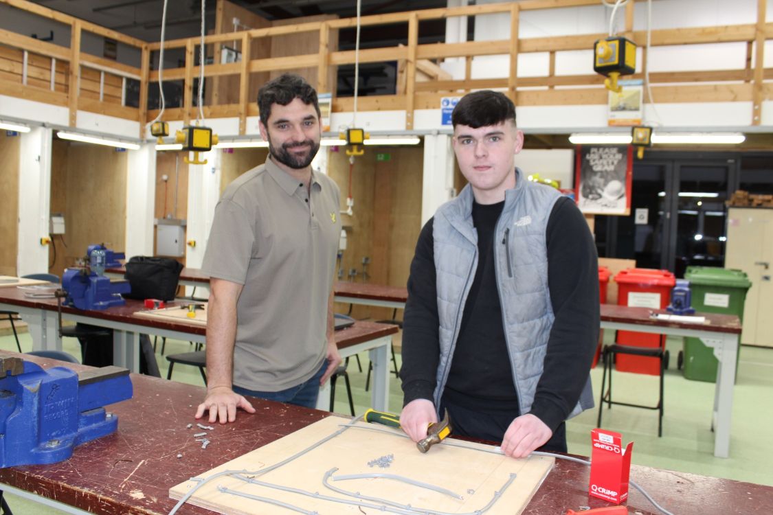 Electrical Lecturer Philip Bonney with Downpatrick man Connor Dowd at the campus electrical workshop